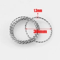Detailed view of 30mm twisted silver ring with 1.3mm wire thickness for DIY jewelry making - Twisted / 30mm / Steel