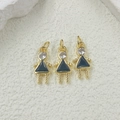 Detailed view of three gold girl pendants with black triangular skirts and zircon stones - Black Pendant