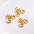 Detailed macro view of three gold bicycle pendants with micro-pave cubic zirconia stones - Bicycle Charm / Gold Bicycle