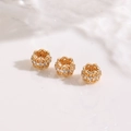Macro shot of three gold-plated flower spacer beads with pavé cubic zirconia for DIY jewelry - Hollow Floral Transfer Bead Rose Gold (ZYN-DMK1251KCG)