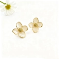 Detailed macro view of cream enamel four-petal flower earrings with 18k gold plating - White Stud Earrings