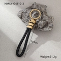 Detailed view of black woven leather keychain with gold ring, 10.5cm length and 21.2g weight - Black Gold Minimalist Style (NMSK-G4110-3)