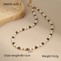 Detail of beaded necklace showing 0.5cm beads and 40+5cm length on a stone tray - White Beads with Dark Gray Iridescent Beads and Gold Metal Beads Style (NMSN-J628-3)