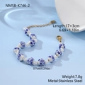 Detailed macro view of 17cm ceramic floral bead bracelet with stainless steel lobster clasp - Bracelet / 17+3cm