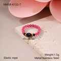 Detailed macro view of elastic beaded ring with pink and black stones and gold beads - Pink and Black Faceted Round Bead Style (NMSR-K722-7)