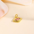 Macro shot of 18k gold plated eye-shaped pendant with pink marquise zircon - Pink