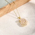 Elegant gold-plated shell pendant necklace with micro-pave pearls on a box chain - Golden Conch