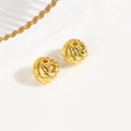 Macro detail of golden spiral hollow metal beads for jewelry and DIY crafting - Gold Hollow Spiral