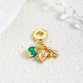 Macro shot of gold travel charms featuring green enamel globe, camera, and airplane - Green Globe Vintage Camera Airplane (ZYN-DMK900G-1)
