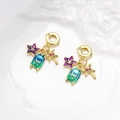 Detailed close-up of golden tropical charms with enamel flower and palm tree bead elements - Purple Flower Tropical Charm (ZYN-DMK994G-1)