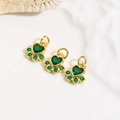 Macro shot of 18k gold plated cat paw pendants with green cubic zirconia inlay - Green