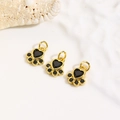 Macro shot of three gold dog paw pendants with black cubic zirconia for DIY jewelry making - Black