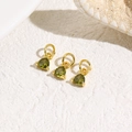 Detailed view of three gold triangle charms with green pear-cut zircon on white rock - Olive Green