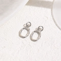 Detail of silver oval charms with unique hammered texture and shiny metallic finish - Silver Hammered Irregular Loop (ZYN-DMK1021P)