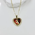 Macro detail of heart-shaped gold pendant featuring red enamel Virgin Mary and zircon border - St. Therese Style (DMK1151G-14A)