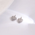 Macro detail of heart-shaped silver charms with sparkling pavé zircons for DIY jewelry - White Heart