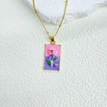 Detailed close-up of a tarot-style rectangle enamel pendant with red rose and golden chain - Rose - Gradient Pink & Purple Background - Necklace Included (ZYN-DMK1165G-3A Plus Necklace)