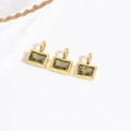Macro detail of three rectangular olive green zircon pendants with gold-plated DIY loops - Grass Green