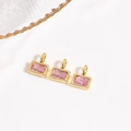 Macro detail of three rectangle pink zircon pendants with gold plating for DIY jewelry - Pink