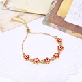 Adjustable gold star evil eye bracelet with red enamel and shimmering cubic zirconia - Red Star