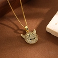 Macro shot of gold devil smile pendant with white and black cubic zirconia stones - Devil Smiley Style (ZYN-DMK674G-A1)