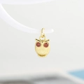 Delicate gold owl pendant with red zircon eyes and engraved feather textures on a stand - Pendant Only / Gold - Red Eyes