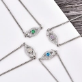 Silver evil eye charm bracelets with green, purple, opal and blue zircon center stones - Blue Opal / White Gold Eye Bracelet
