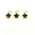 Detailed macro view of three black star pendants with gold metal edges and hanging loops - Black Star Pendants Set