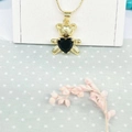 Golden panda pendant necklace with a black heart-shaped stone on a white stand - Necklace Set (ZYN-DMK482G-2) / Black