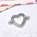 Macro detail of heart-shaped copper connector with multicolored cubic zirconia for DIY jewelry - Silver Heart Connector (ZYN-DMK500-1)