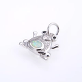 Macro shot of silver frog pendant featuring white opal stone and sparkling zircon inlay - Silver White