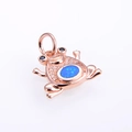 Macro detail of rose gold frog pendant featuring blue opal and sparkling zircon inlay - Rose Gold Blue