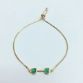 Detailed shot of gold dumbbell-style bracelet with opal-like green stones and slider clasp - Gold Green Opal Bracelet