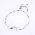 Detail of dolphin charm with blue opal inlay and adjustable silver-tone box chain - Pisces / Platinum Plated Green
