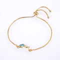 Detail of gold box chain bracelet featuring dolphin charms and blue opal inlay - Pisces / Gold Blue