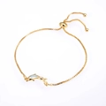 Detailed macro view of a gold dolphin opal pendant on a flexible box chain bracelet - Pisces / Golden White