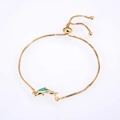 Detailed macro view of the double dolphin charm with green opal and adjustable gold chain - Pisces / Gold Green
