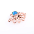 Detalle macro de dije de pulpo con ópalo azul y acabado en oro rosa de calidad - Conector de Pulpo Oro Rosa Ópalo Azul Artificial