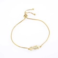 Detail eines verstellbaren Gold-Seepferdchen-Armbands mit weißer Opal-Einlage - Seepferdchen Armband / Gold Rosa Opal