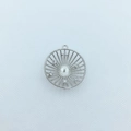 Macro view of a sun-shaped silver-plated pendant with radiant lines and zircon accents - Round / Silver