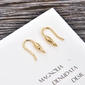 Macro view of gold-plated U-shaped DIY earring hooks with spiral texture on wood background - Gold (kk09-g)
