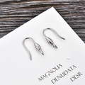 Close-up of silver fishhook earring wires with coil and loop for DIY jewelry making - Silver (kk09-p)
