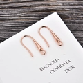Close-up of rose gold plated U-shaped earring hooks with spiral texture and small loops - Rose Gold (kk11-r)