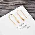 Detail view of gold-plated U-shaped earring hooks with small rings on display card - Gold (kk12-g)