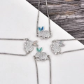 Detail of rabbit charms with micro-paved crystals and colorful synthetic opal inlay - Blue Opal / Platinum Rabbit Bracelet
