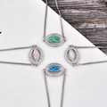 Detail of evil eye bracelets featuring opal center stones and sparkling zircon settings - Blue Opal / White Gold Eye Bracelet