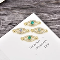 Macro view of gold evil eye jewelry connectors with opal centers and white zircons - Blue Opal Connector / Gold Eye