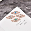 Detailed view of rose gold evil eye connectors with opal inlay and zircon stones - Blue Opal Connector / Rose Gold Evil Eye