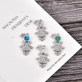 Detail of four crown girl pendants with colorful opal stones and micro-pave zircons - Blue Opal / Platinum Color Girl