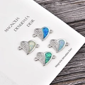 Detail view of heart-shaped opal connector charms with cubic zirconia and double loops - Platinum Heart Blue Opal Connector
